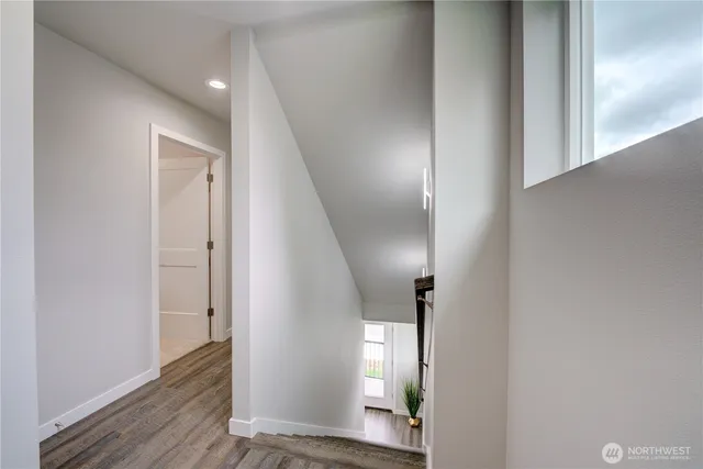 a bedroom with a bed and a flat tv screen on the dresser