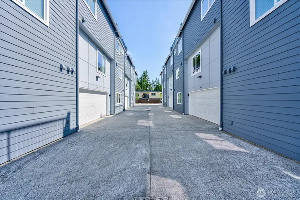 a view of house with yard and a garage