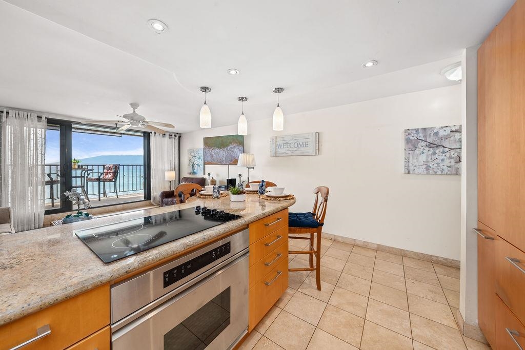 3785 Lower Honoapiilani Road, Unit 208 Lahaina, HI 96761 - Photo 9 of 50 a kitchen with stainless steel appliances granite countertop a sink and a counter top space