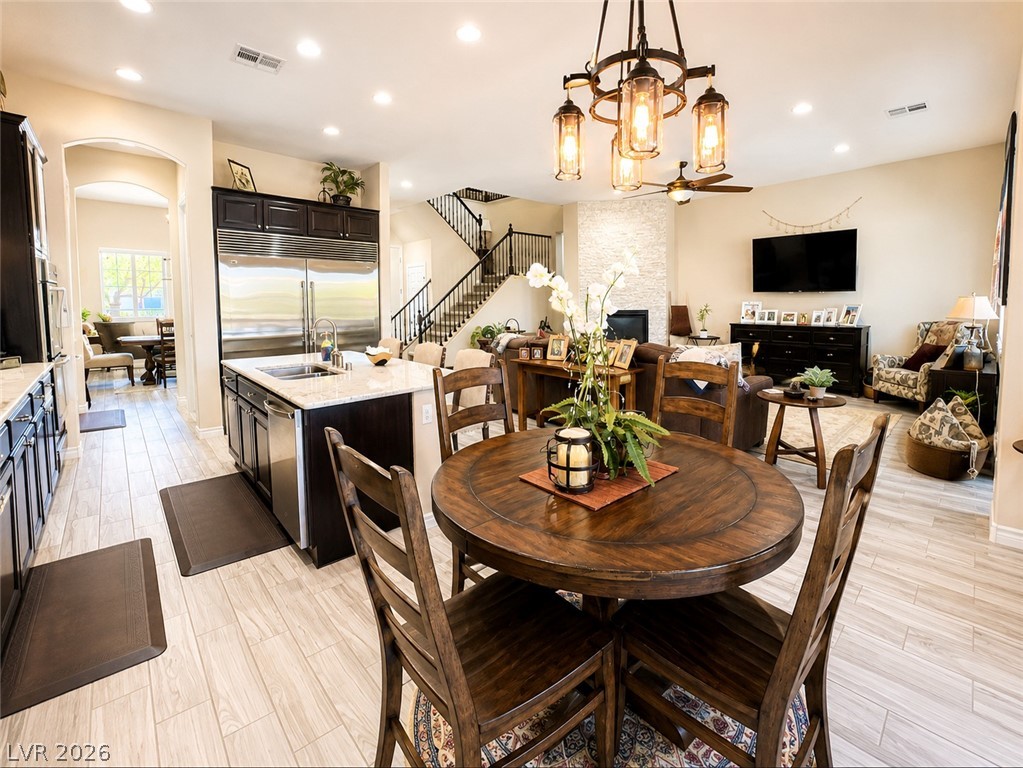 9724 University Ridge Avenue Las Vegas, NV 89149 - Photo 7 of 61 An inviting open-concept layout connects kitchen, dining, and living spaces, perfect for entertaining.