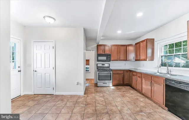 a large kitchen with cabinets and stainless steel appliances