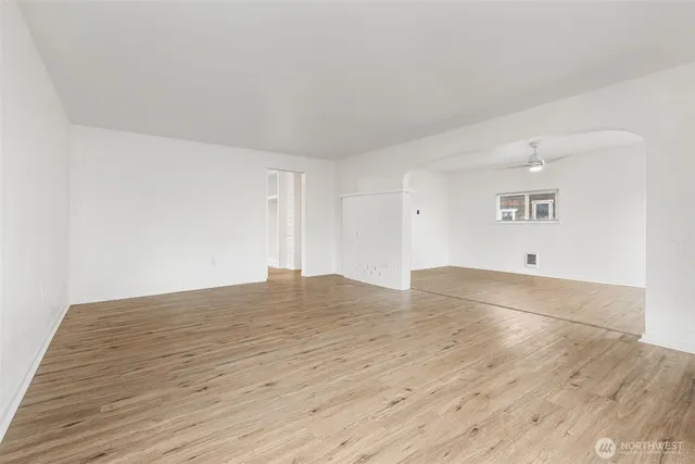 a view of empty room with wooden floor