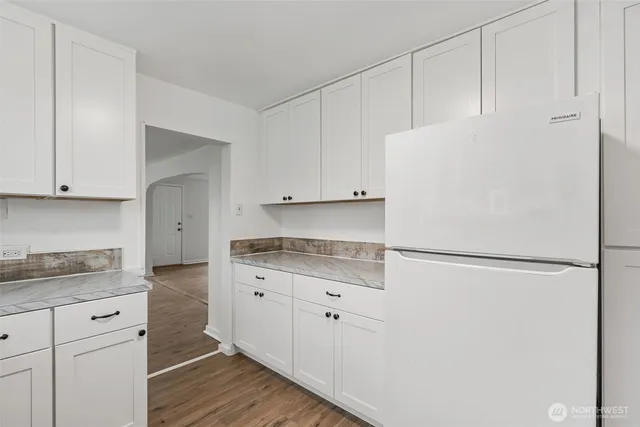 a white refrigerator freezer sitting inside of a kitchen