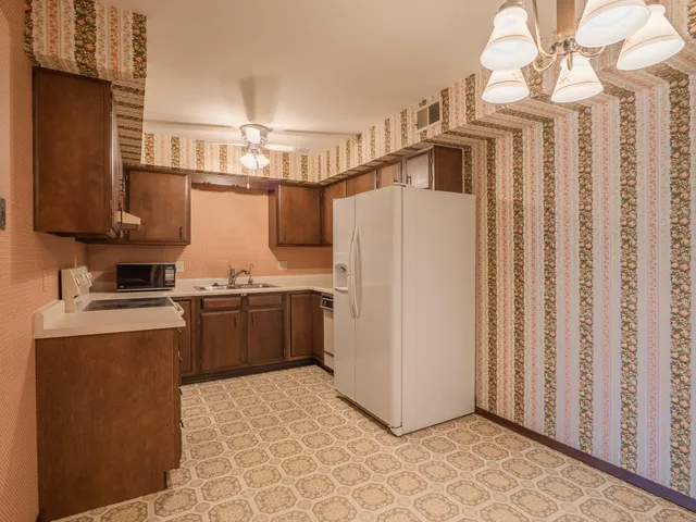 a kitchen with stainless steel appliances a refrigerator and a stove