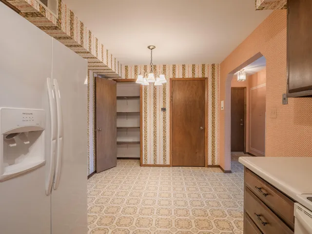 a view of a kitchen with a sink and a refrigerator