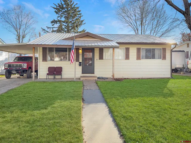 a front view of a house with a yard and porch