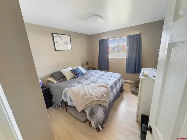 a bedroom with a bed and window