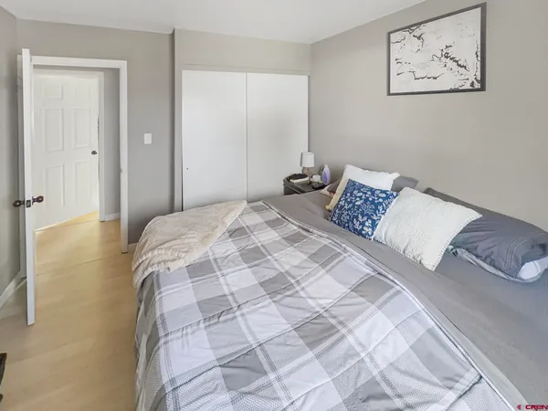 a bedroom with a bed and a painting on the wall