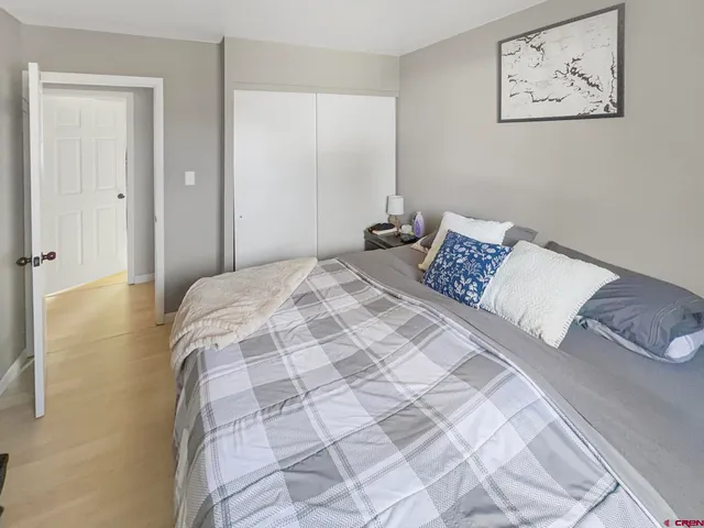 a bedroom with a bed and a painting on the wall