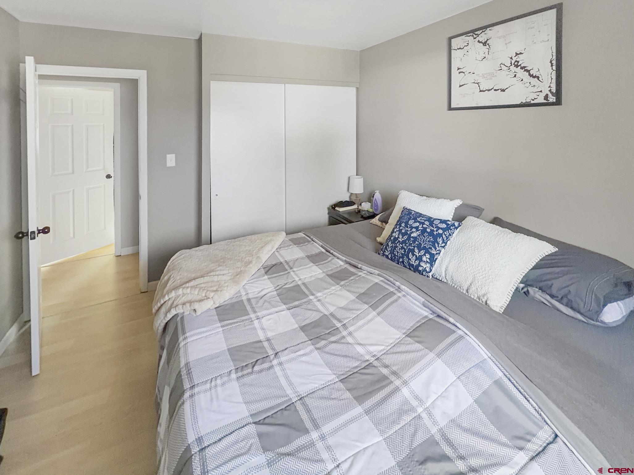 717 East 3rd Street Cortez, CO 81321 - Photo 13 of 26 a bedroom with a bed and a painting on the wall