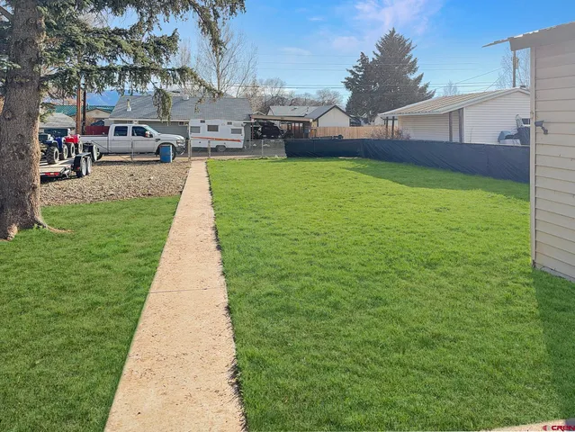 a view of a backyard with a garden and plants