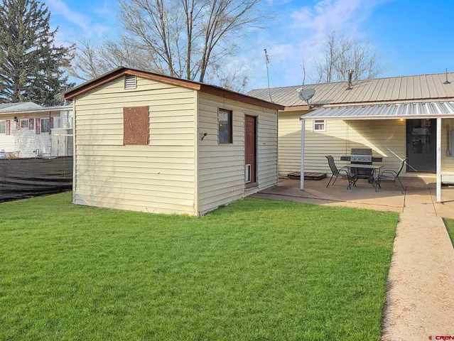 a view of a house with a yard porch and sitting area