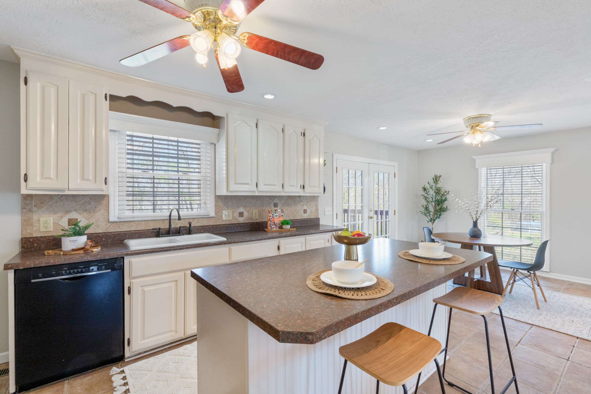 110 Redbud Drive Dickson, TN 37055 - Photo 17 of 43 a kitchen with a dining table chairs and white cabinets