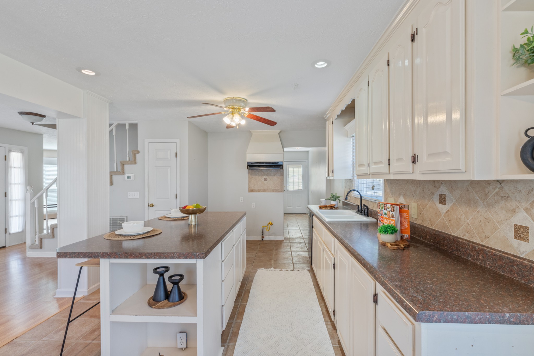 110 Redbud Drive Dickson, TN 37055 - Photo 18 of 43 a kitchen with granite countertop a sink a stove and cabinets