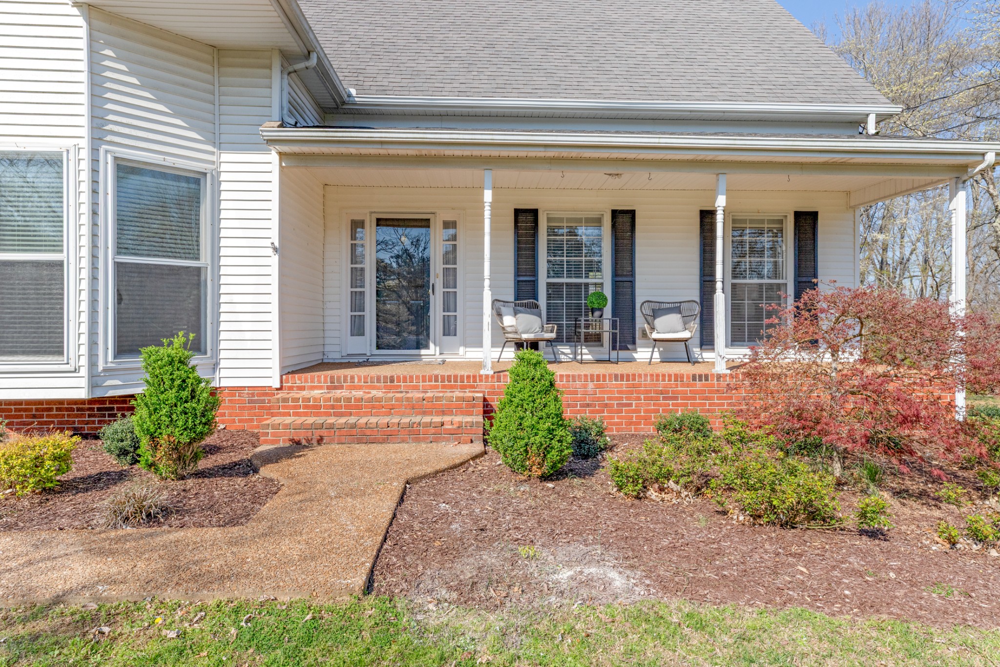 110 Redbud Drive Dickson, TN 37055 - Photo 2 of 43 a front view of a house with garden and outdoor seating
