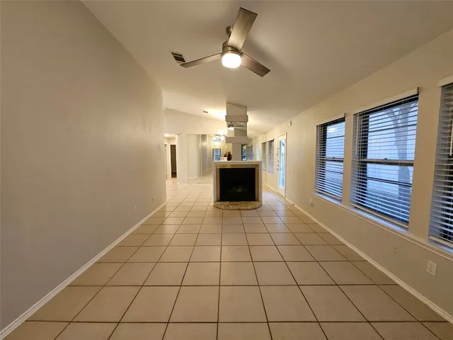 a view of an empty room and fire place