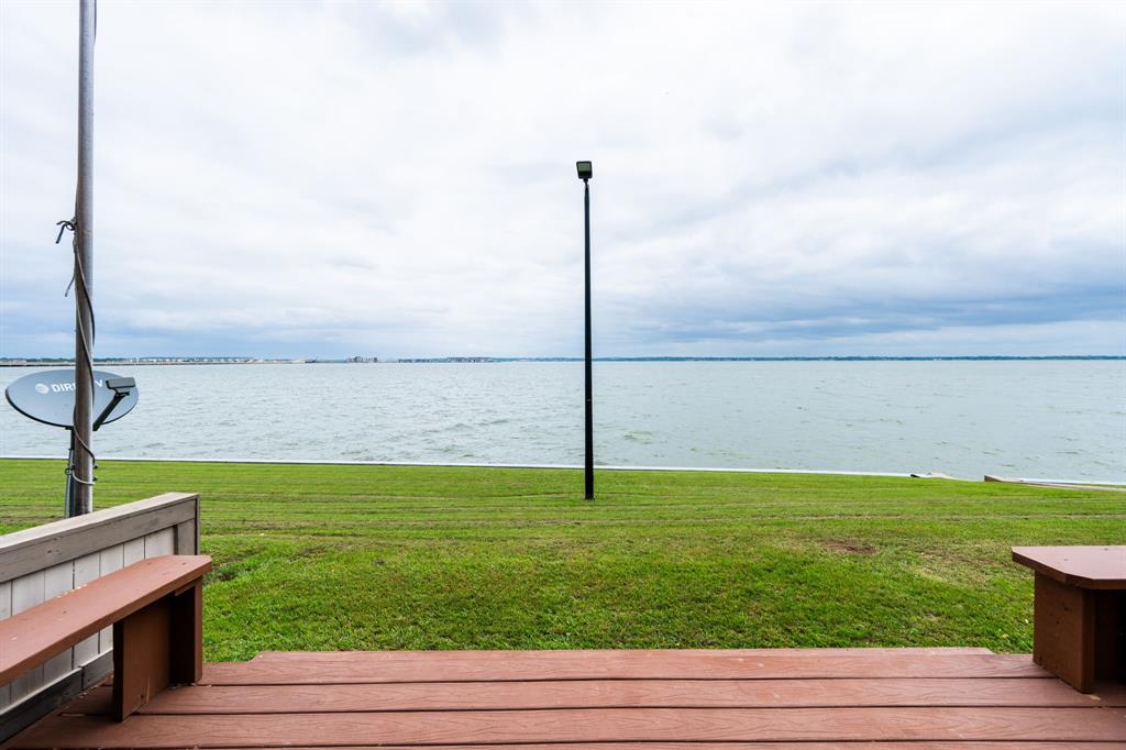 4610 Chaha Road, Unit 106 Garland, TX 75043 - Photo 19 of 25 a view of a lake with a yard
