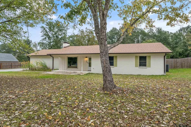 a house with green field in front of it