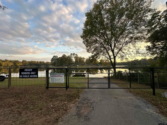 a view of outdoor space with deck and lake view