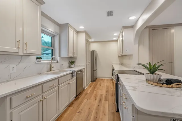 a kitchen with a sink and appliances