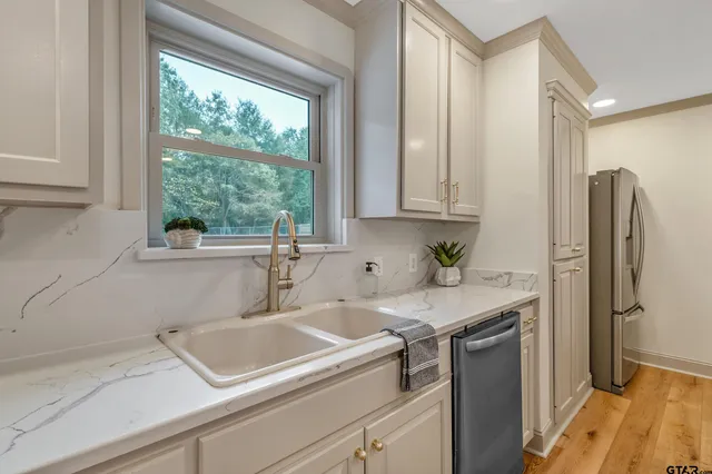 a view of a kitchen with a sink and refrigerator