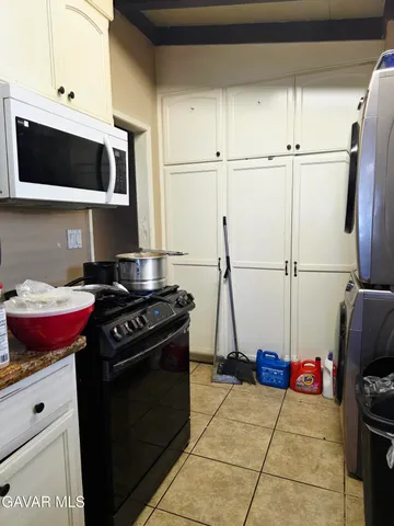 a kitchen with stainless steel appliances granite countertop a stove and a microwave