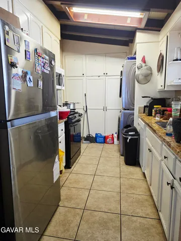 a kitchen with refrigerator and cabinets