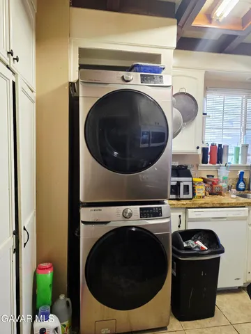 a utility room with sink dryer and washer