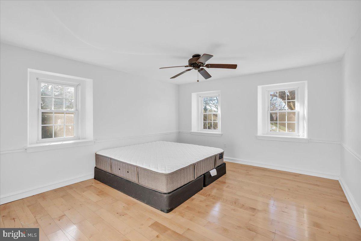 163 Welsh Road Huntingdon Valley, PA 19006 - Photo 17 of 27 a spacious bedroom with a large bed and a window