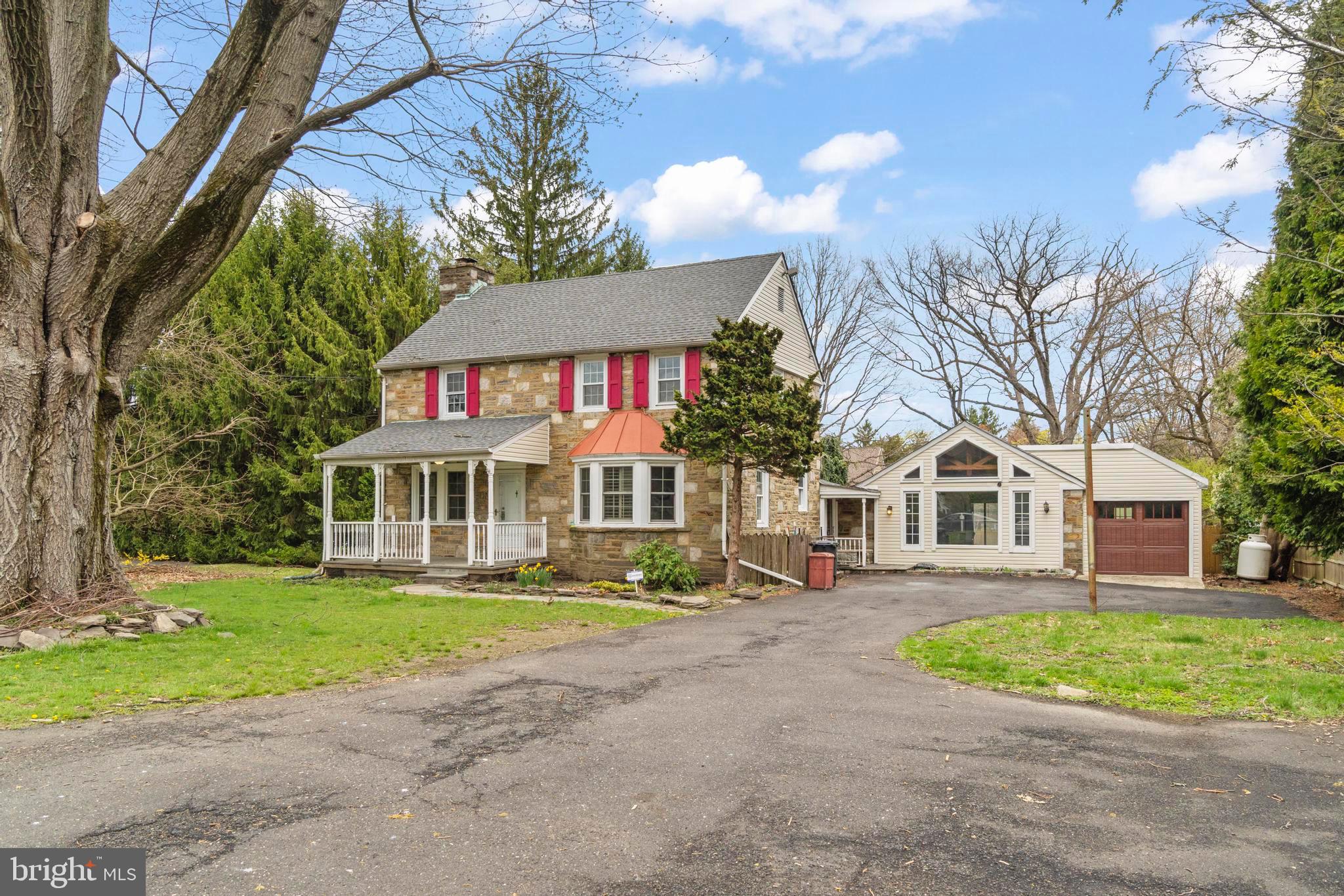 163 Welsh Road Huntingdon Valley, PA 19006 - Photo 2 of 27 a front view of a house with a yard and trees