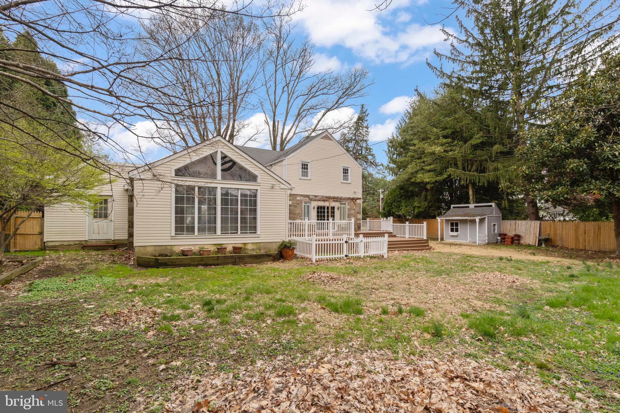 163 Welsh Road Huntingdon Valley, PA 19006 - Photo 24 of 27 a house that has a big yard with large trees