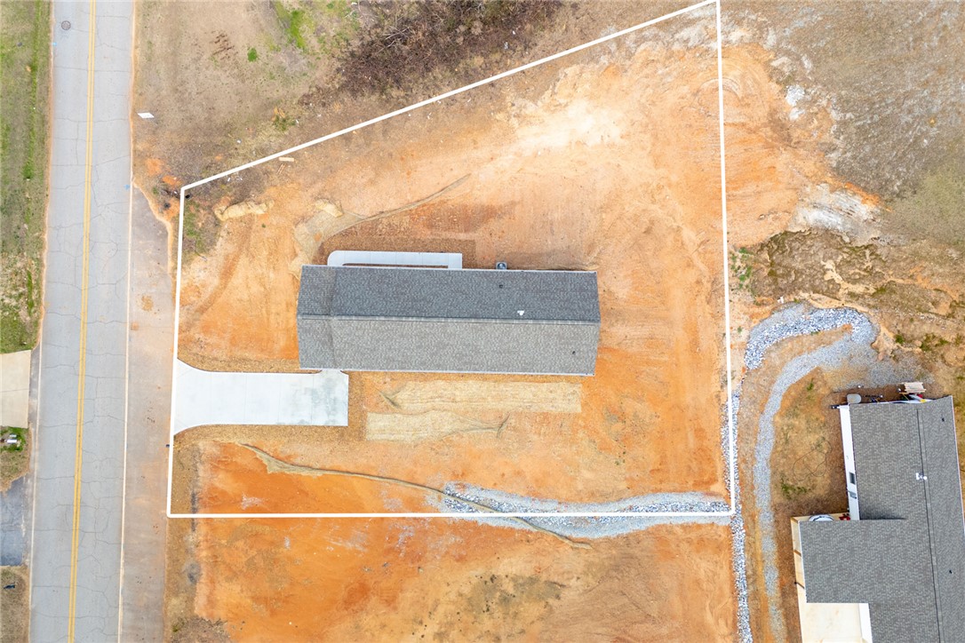 115 Riley Street Westminster, SC 29693 - Photo 43 of 46 An aerial perspective showcases a newly constructed residence on a spacious lot, awaiting its landscape transformation.