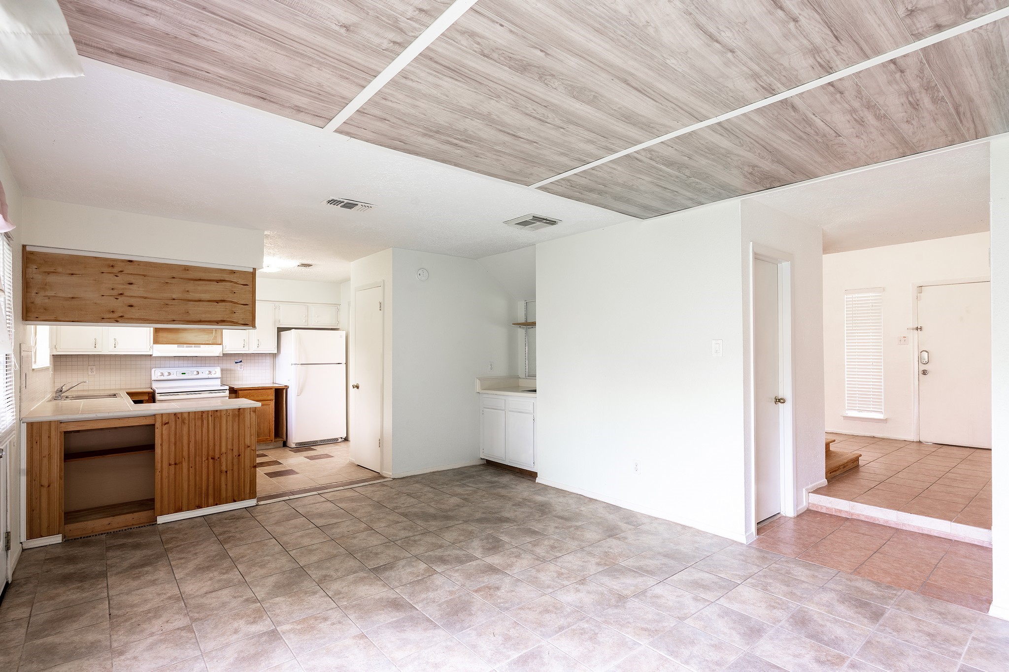 4423 Mossygate Drive Spring, TX 77373 - Photo 15 of 38 a view of a kitchen with a sink and a refrigerator
