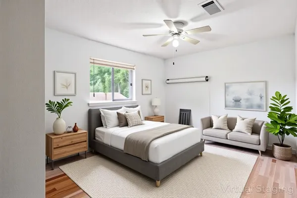 a bedroom with a bed couch and window