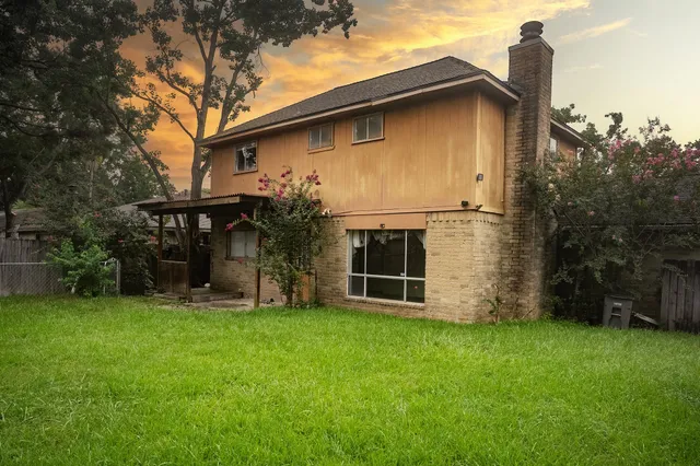 a view of a house with yard and a garden