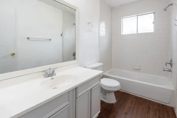 a bathroom with a sink a toilet and a bathtub