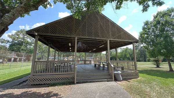 a view of a roof deck with a chair and table