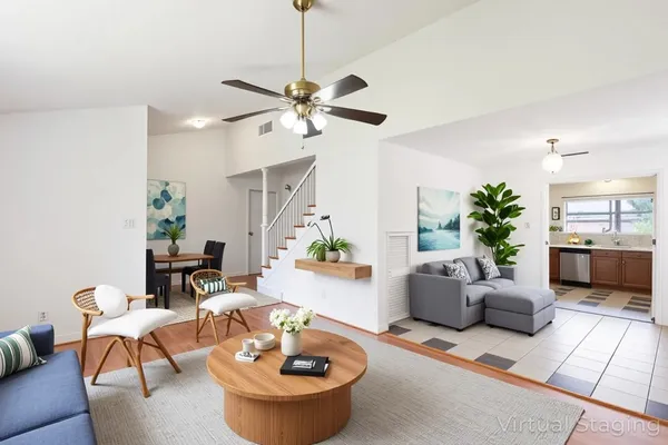 a living room with furniture and a chandelier