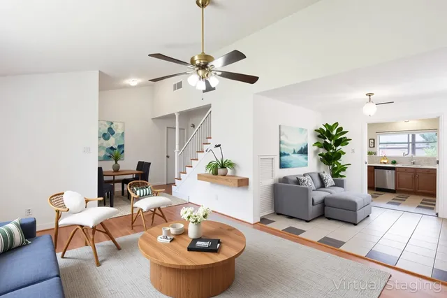 a living room with furniture and a chandelier