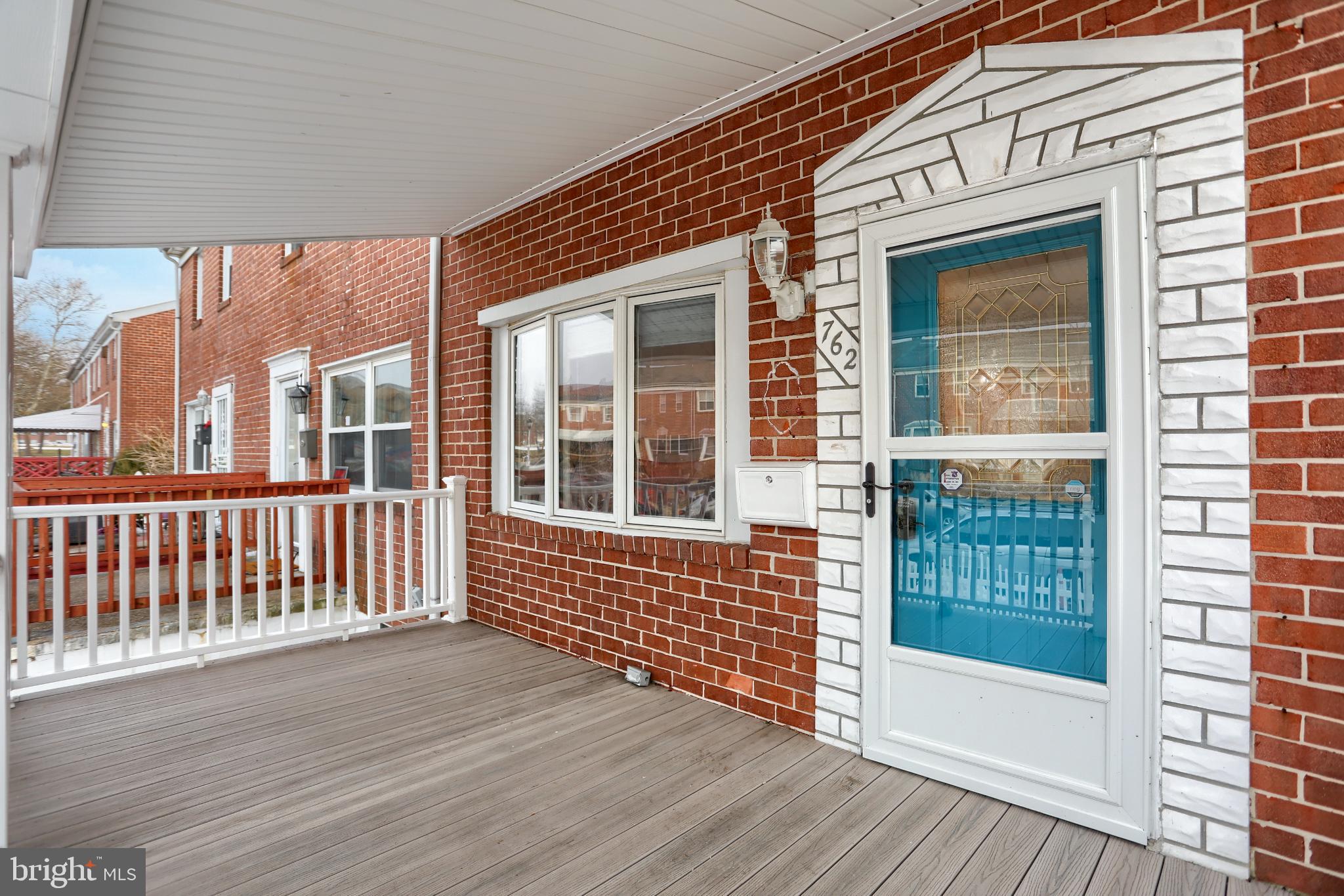 762 Seawall Road Baltimore, MD 21221 - Photo 3 of 35 Charming entryway with vibrant blue door.