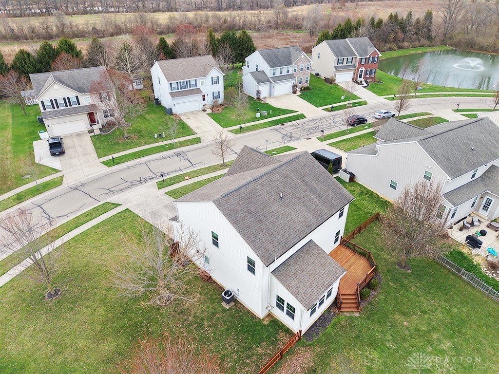 1978 Spring Ridge Drive Xenia, OH 45385 - Photo 35 of 44 This elevated view showcases a lovely suburban neighborhood with lush green lawns and a tranquil pond.