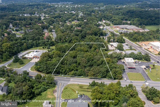 an aerial view of residential houses with outdoor space and street view