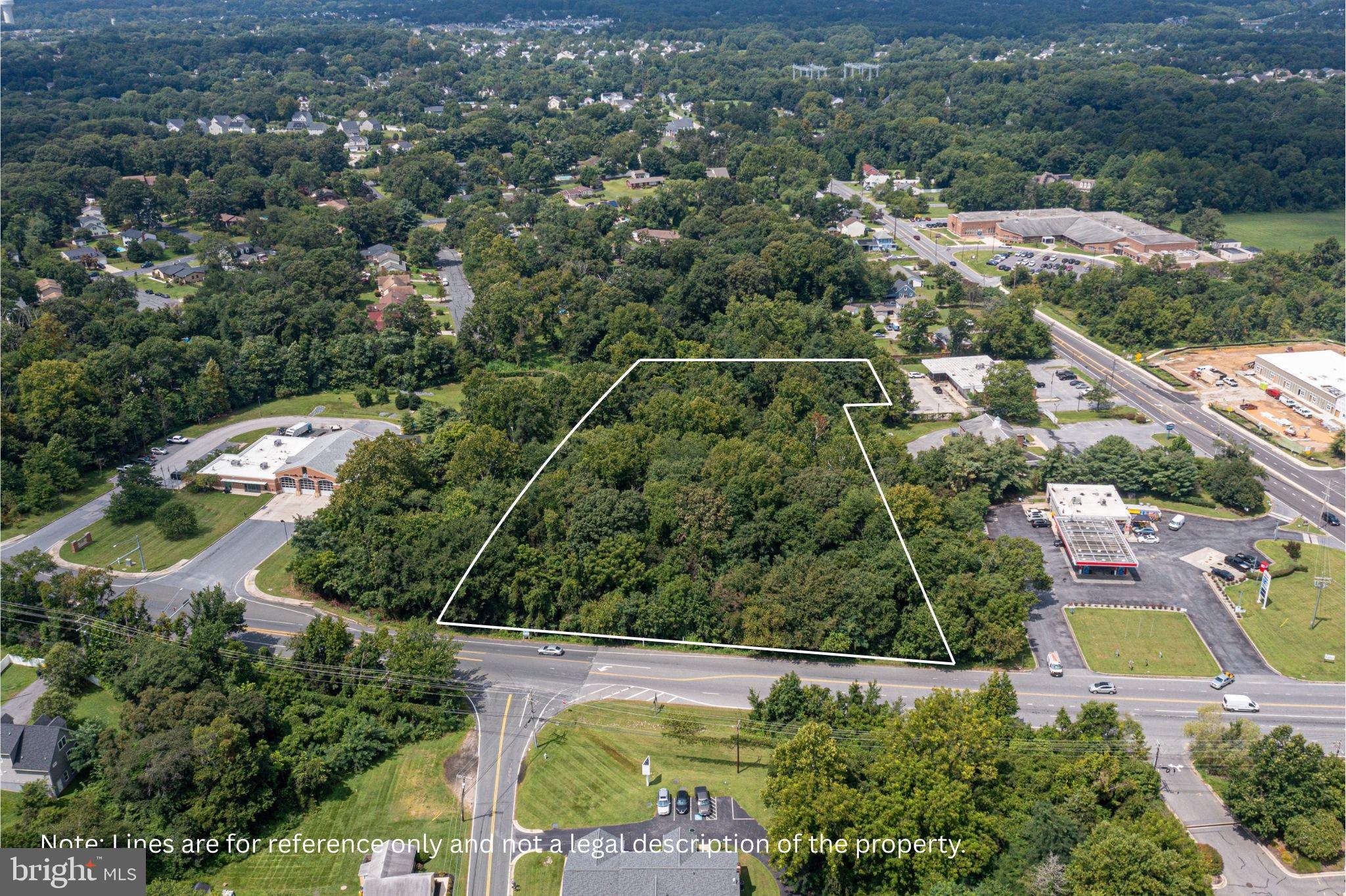 an aerial view of residential houses with outdoor space and street view