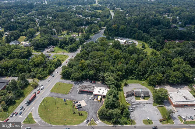 an aerial view of a house with outdoor space and swimming pool
