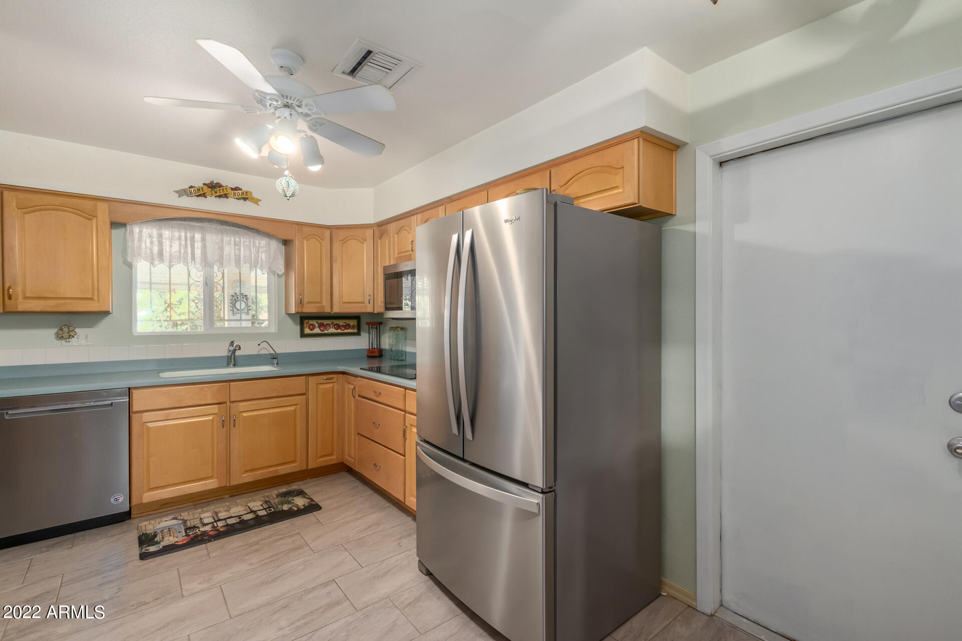5853 East Adobe Road Mesa, AZ 85205 - Photo 13 of 26 a kitchen with stainless steel appliances granite countertop a refrigerator and a sink