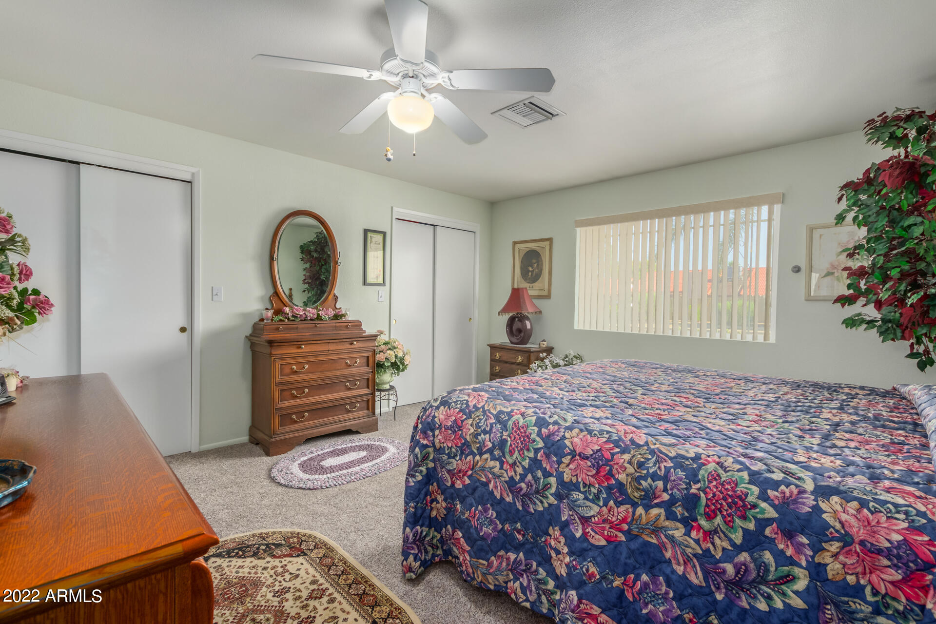 5853 East Adobe Road Mesa, AZ 85205 - Photo 17 of 26 a bedroom with a bed and a chandelier