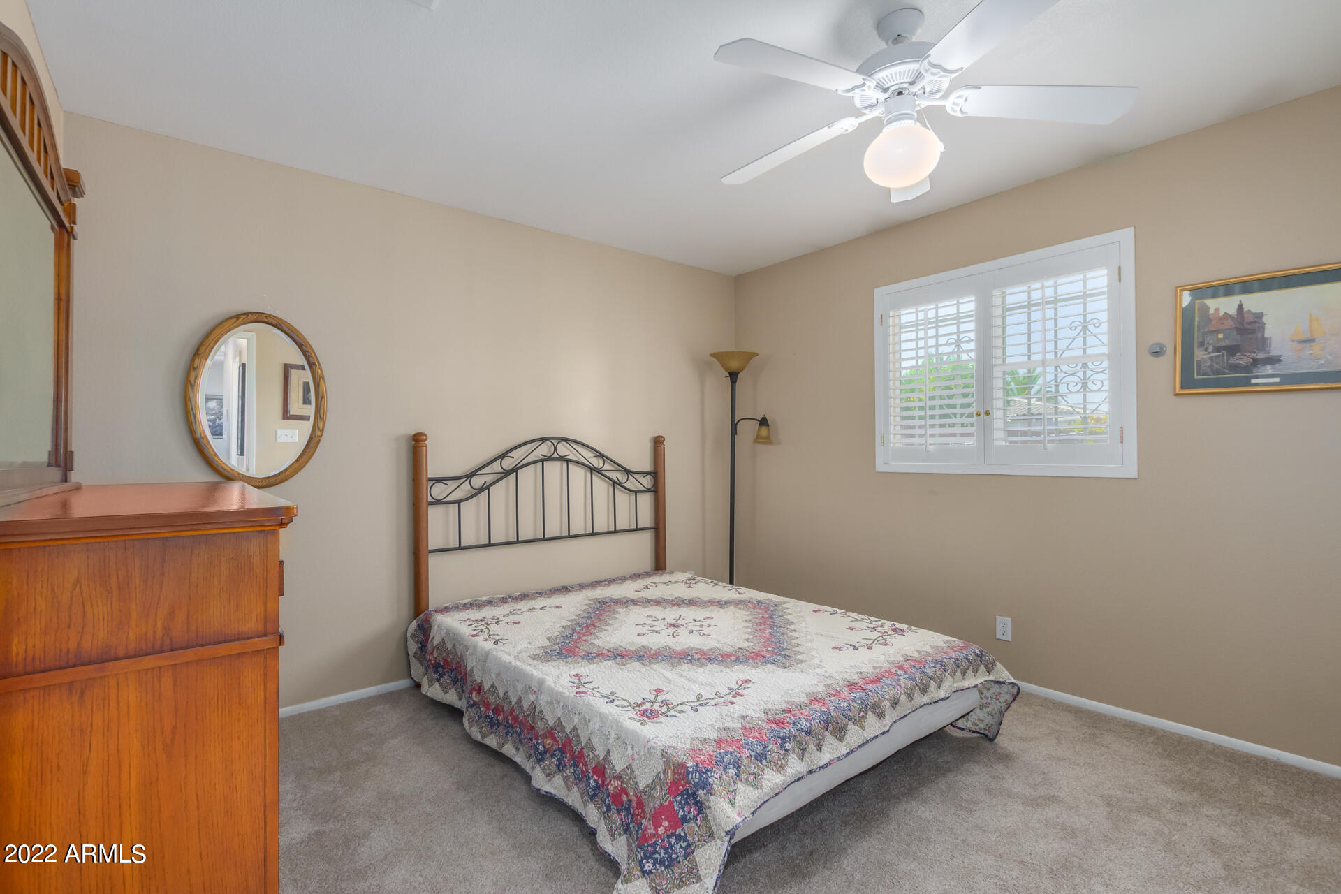 5853 East Adobe Road Mesa, AZ 85205 - Photo 20 of 26 a bedroom with a bed chandelier and a window