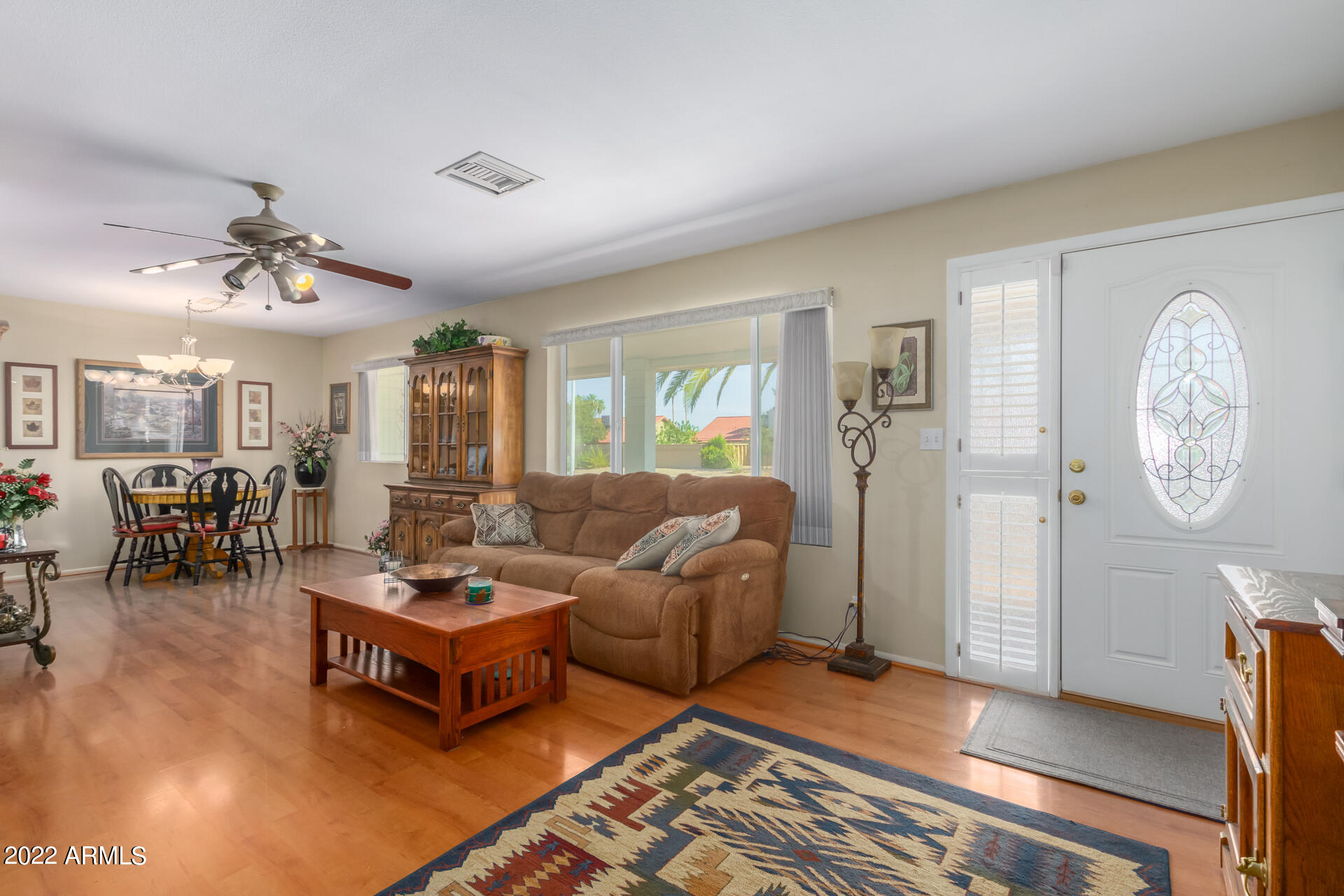 5853 East Adobe Road Mesa, AZ 85205 - Photo 4 of 26 a living room with furniture a clock on wall and a window