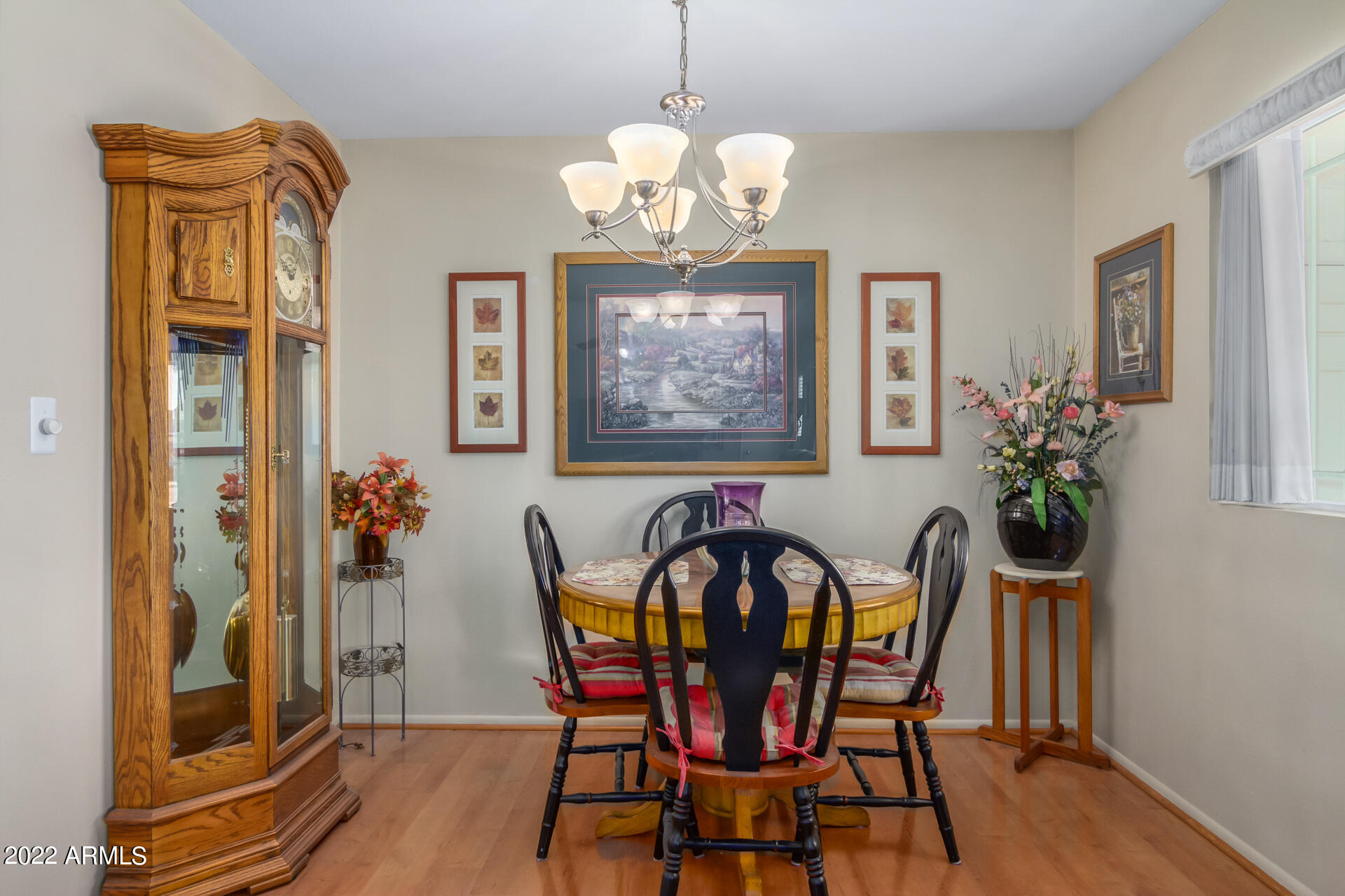 5853 East Adobe Road Mesa, AZ 85205 - Photo 8 of 26 a view of a dining room with furniture wooden floor and a chandelier