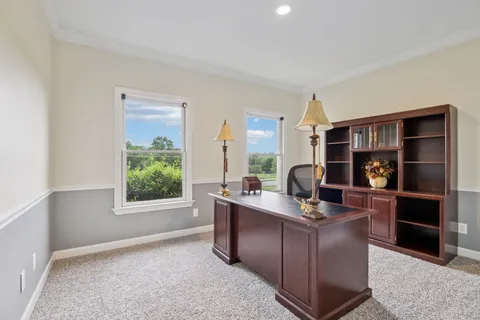 a kitchen with stainless steel appliances kitchen island granite countertop a table chairs and a refrigerator